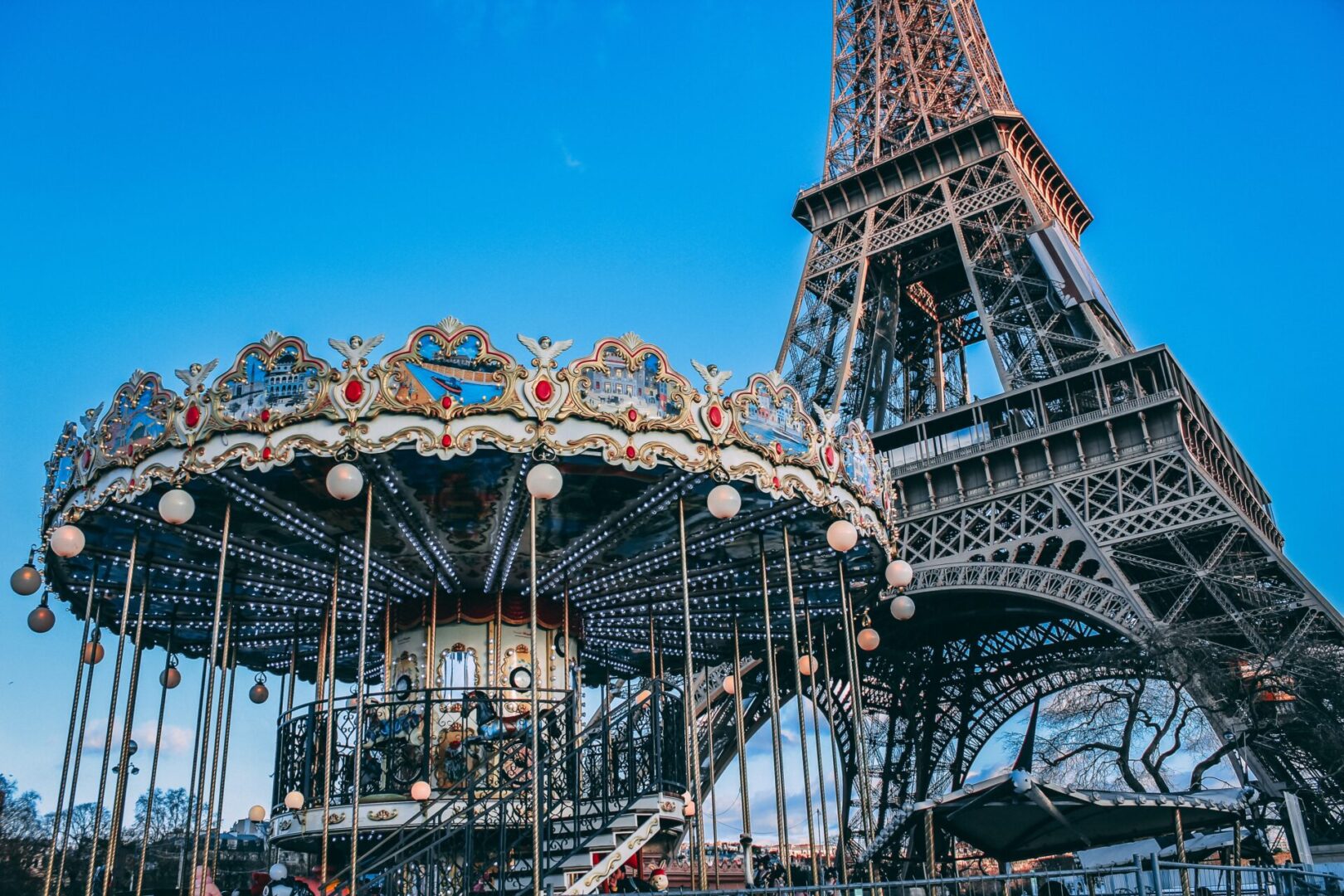 A carousel in front of the eiffel tower.
