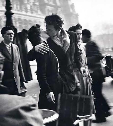 A man and woman hugging on the street.