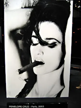 A woman smoking a cigar with her mouth open.
