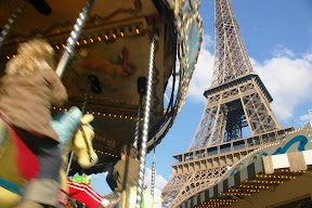 A carousel and the eiffel tower in paris.