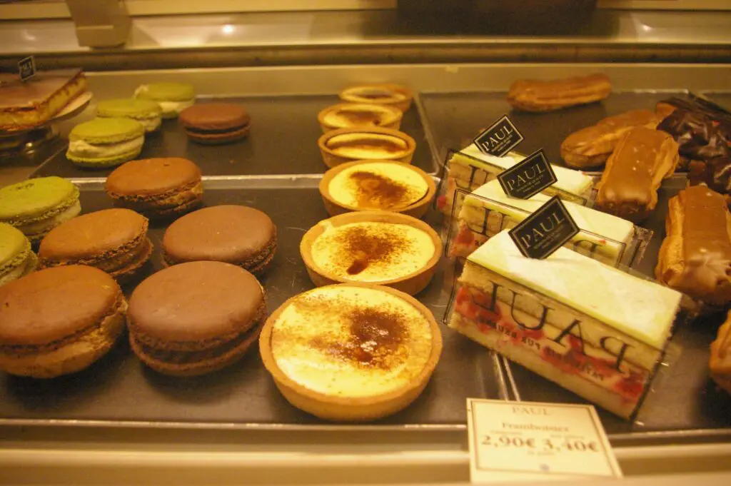 A display case filled with lots of different pastries.