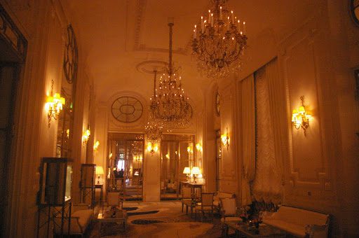 A large room with chandeliers and chairs in it