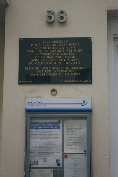 A plaque on the wall of a building