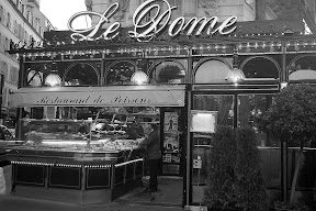 A black and white photo of a restaurant in paris.