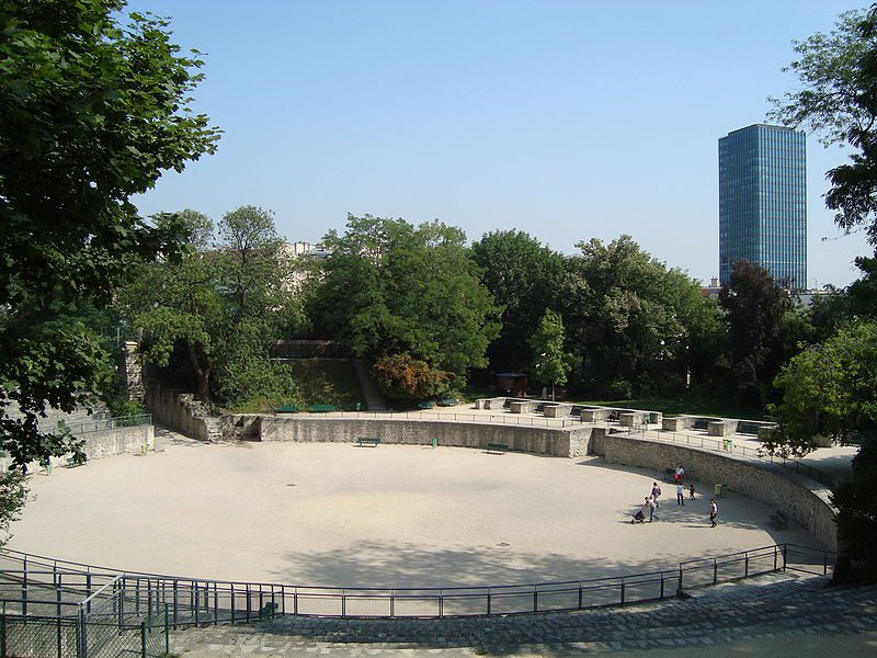 A large concrete ring in the middle of a park.