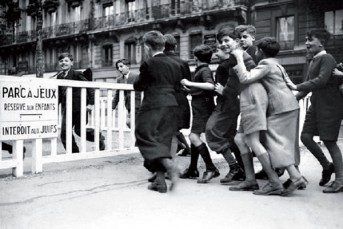 A group of children are playing around in the street.
