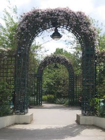A large metal arch with flowers on it.