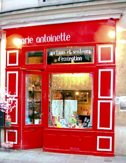 A red store front with white trim and the words " marie antoinette ".