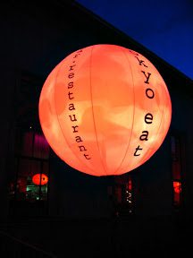 A large inflatable ball is lit up outside.