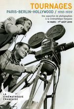 Two men are looking at a movie camera.